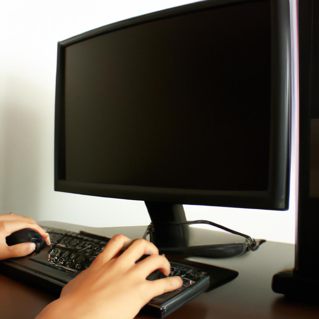Person working on computer desk